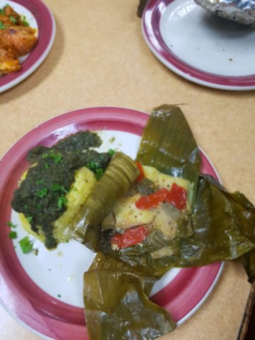 Liboke - wrapped fish in banana leaves, with rice and spinach